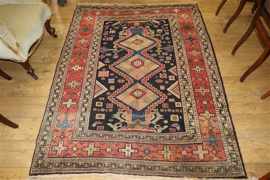 A Caucasian rug with triple medallion on a blue ground and two worn Persian rugs 210 x 120cm, 205 x 135cm and 195 x 145cm